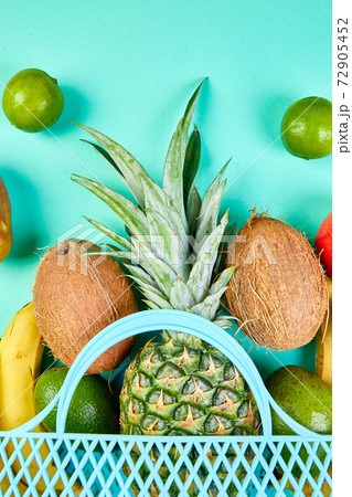 Grocery shopping bag with organic exotic fruits on blue background. 72905452
