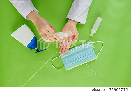 Doctor applying sanitizer gel 72905756