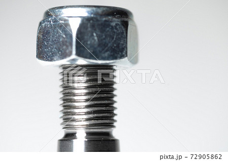 Close-up of the thread and nut on the studs of the ball joint of the front auto suspension Close-up of the thread and nut on the studs of the ball joint of the front auto suspension 72905862