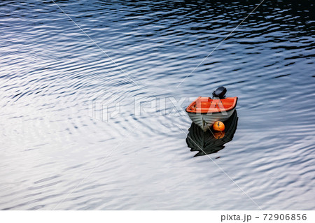 motor boat parked in calm water 72906856