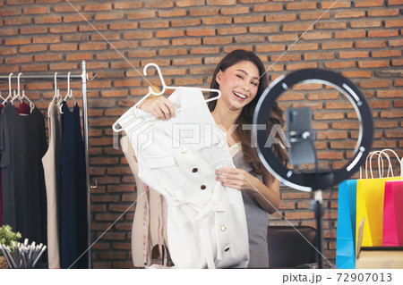 Asian young woman live streaming for sale fashion clothing is blogger presenting for social people. Her is influencer in social online. 72907013