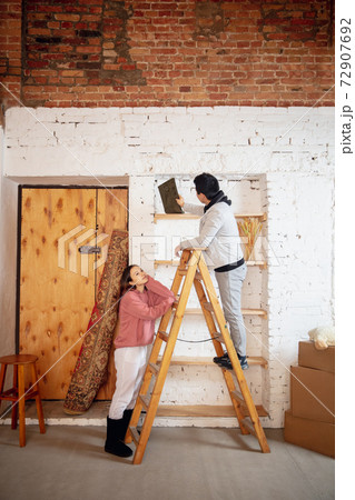 New property owners, young couple moving to new home, apartment, look happy New property owners, young couple moving to new home, apartment, look happy 72907692