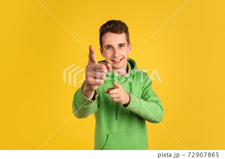 Portrait of young caucasian man isolated on yellow studio background Portrait of young caucasian man isolated on yellow studio background 72907865