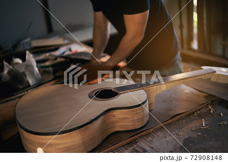 craft man making guitar on wood table, capenter working concept craft man making guitar on wood table, capenter working concept 72908148