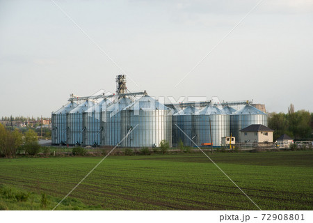 Grain elevators among spring landscape 72908801
