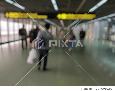 Blurred image abstract background of people or passenger walking in or hurry up in airport transport terminal and lounge interior from airplanes are walking to the immigration gates. Blurred image abstract background of people or passenger walking in or hurry up in airport transport terminal and lounge interior from airplanes are walking to the immigration gates. 72909585