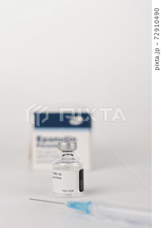 Covid-19 vaccine vial, syringe with needle and paper box with vials. Medical concept. Covid-19 vaccine vial, syringe with needle and paper box with vials. Medical concept. 72910490