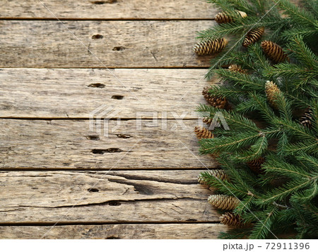 Christmas greeting background for postcards, web pages and greetings.Fir branches on a wooden ancient background with place for text. Christmas greeting background for postcards, web pages and greetings.Fir branches on a wooden ancient background with place for text. 72911396
