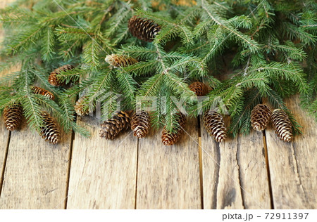 Christmas greeting background for postcards, web pages and greetings.Fir branches on a wooden ancient background with place for text. Christmas greeting background for postcards, web pages and greetings.Fir branches on a wooden ancient background with place for text. 72911397