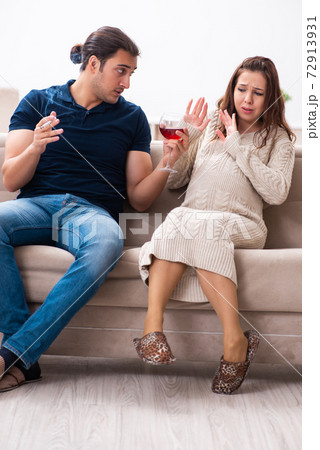 Man and pregnant woman in harmful habits concept 72913931