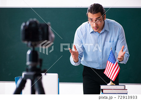 Young handsome teacher recording video for his blog 72913933
