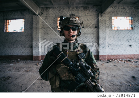 Close-up of a professional fully equipped soldier looking at camera. 72914871
