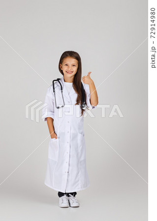 Cute child in doctor coat with stethoscope Cute child in doctor coat with stethoscope 72914980