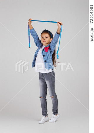 happy little girl holding tape measure 72914981