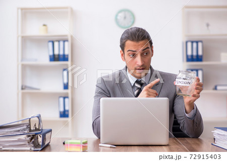 Young male employee in pension concept at workplace 72915403