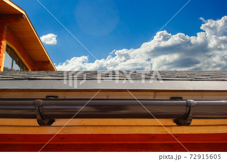 Water drain system on the roof of the house. Brown plastic drain. Water drain system on the roof of the house. Brown plastic drain. 72915605