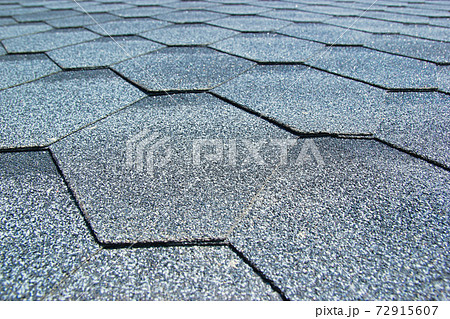 Gray soft roof on the roof of the house. Close-up. Gray soft roof on the roof of the house. Close-up. 72915607