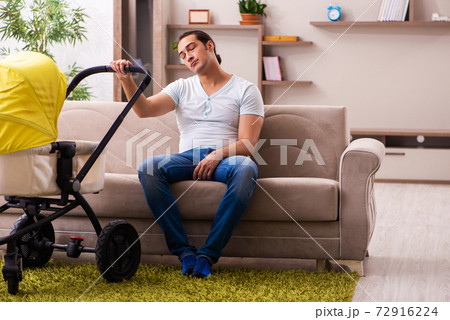 Young male contractor looking after new born at home Young male contractor looking after new born at home 72916224