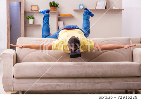 Young man student with virtual glasses at home Young man student with virtual glasses at home 72916229