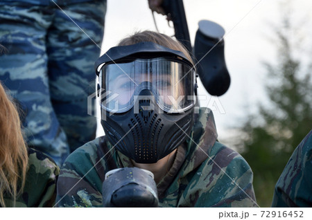 Paintball sport player girl in protective camouflage uniform Paintball sport player girl in protective camouflage uniform 72916452