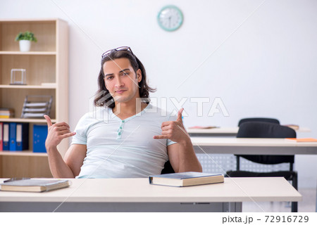 Young male student preparing for exam in the classroom Young male student preparing for exam in the classroom 72916729
