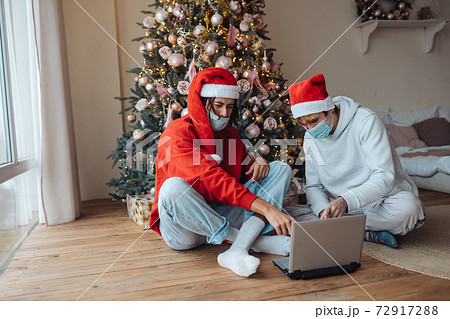 Two friends near the laptop is interacting through video calls. 72917288