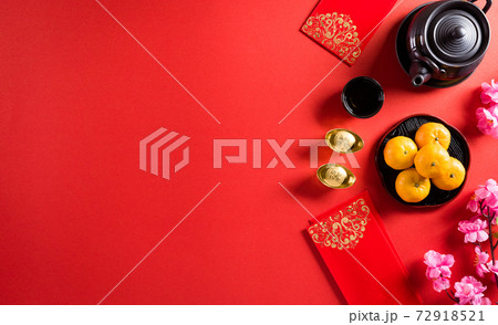 Chinese new year festival decorations pow or red packet, orange and gold ingots or golden lump on a red background. Chinese characters FU in the article refer to fortune good luck, wealth, money flow. Chinese new year festival decorations pow or red packet, orange and gold ingots or golden lump on a red background. Chinese characters FU in the article refer to fortune good luck, wealth, money flow. 72918521