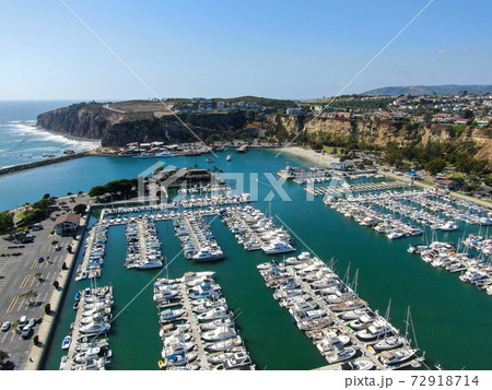 Aerial view of Dana Point Harbor and her marina with yacht and sailboat. 72918714