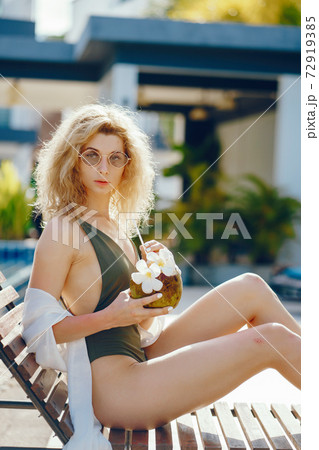 girl drinking fresh juice from a coconut girl drinking fresh juice from a coconut 72919385