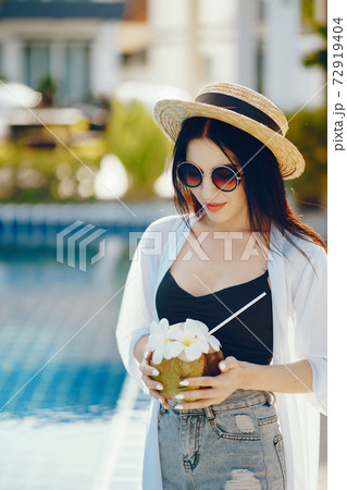 girl drinking fresh juice from a coconut girl drinking fresh juice from a coconut 72919404