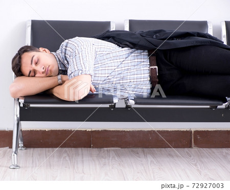 Man sleeping on the chairs in airport Man sleeping on the chairs in airport 72927003