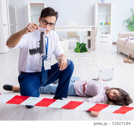 Forensic investigator at the crime scene investigating woman mur 72927194