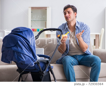 Young father looking after newborn baby at home Young father looking after newborn baby at home 72930364