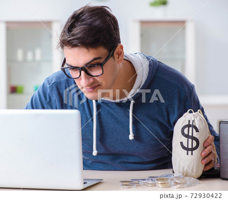 Young man mining bitcoins at home 72930422