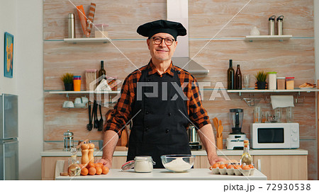 Portrait of chef wearing bonete looking at camera Portrait of chef wearing bonete looking at camera 72930538