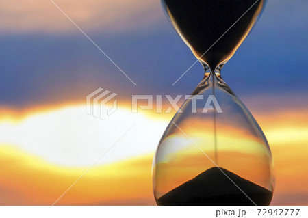 Hourglass on the background of a sunset. The value of time in life. An eternity. 72942777