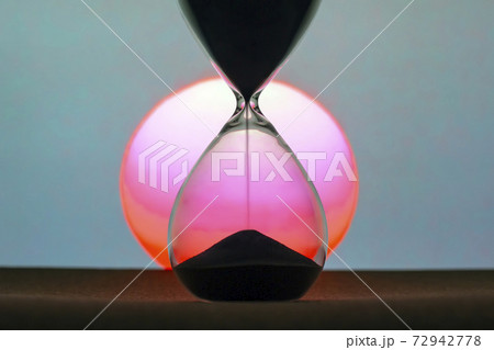 Hourglass on the background of a sunset. The value of time in life. An eternity. 72942778