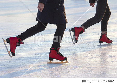 different people are actively skating on an ice rink. Hobbies and sports. Vacations and winter activities. different people are actively skating on an ice rink. Hobbies and sports. Vacations and winter activities. 72942802