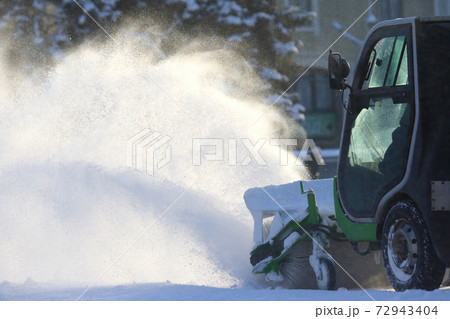 street cleaning the city from snow with the help of special machinery 72943404
