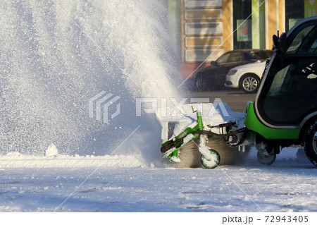 street cleaning the city from snow with the help of special machinery 72943405
