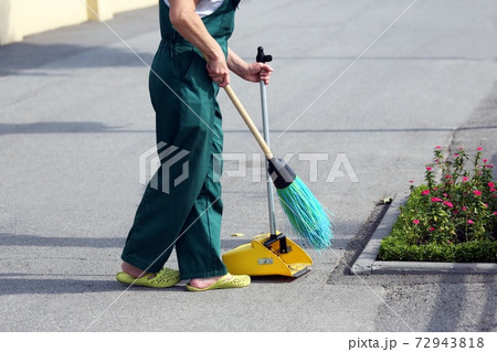 the janitor sweeping broom street 72943818