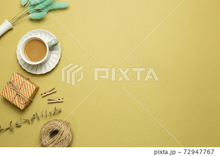 Gift box, cup of coffee with dry plant on khaki background. flat lay, top view, copy space Gift box, cup of coffee with dry plant on khaki background. flat lay, top view, copy space 72947767