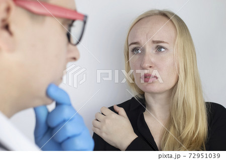A woman suffers from shoulder pain. Shoulder injury, tendonitis, sprain, or tendon inflammation. The concept of acute pain and inflammation in different parts of the body. On examination by a doctor A woman suffers from shoulder pain. Shoulder injury, tendonitis, sprain, or tendon inflammation. The concept of acute pain and inflammation in different parts of the body. On examination by a doctor 72951039
