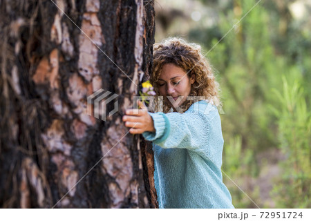 People and save nature concept with woman hugging a tree with love and care - save the planet and climate change global warmin worried problem - beautiful female and big pine in the forest People and save nature concept with woman hugging a tree with love and care - save the planet and climate change global warmin worried problem - beautiful female and big pine in the forest 72951724