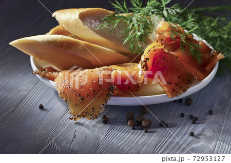 Smoked salmon with bread , dill and pepper . Smoked salmon with bread , dill and pepper . 72953127