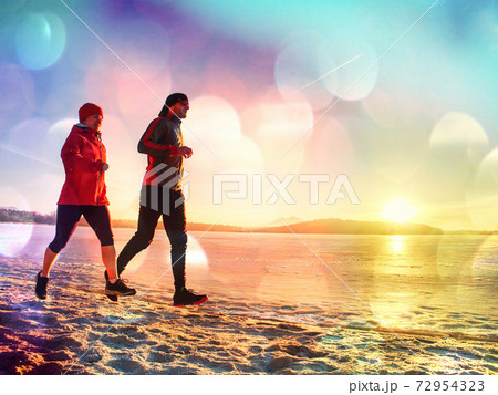 Couple Running along sea shore Couple Running along sea shore 72954323
