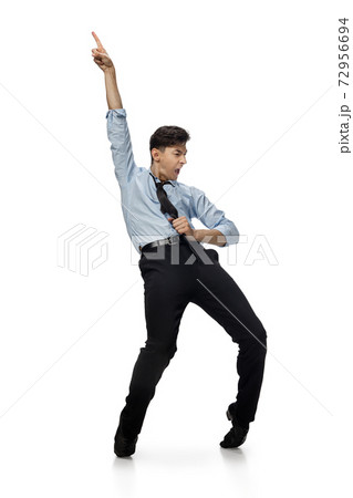 Happy young man dancing in casual clothes or suit, remaking legendary moves of celebrity from culture history 72956694