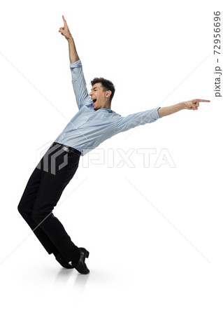 Happy young man dancing in casual clothes or suit, remaking legendary moves of celebrity from culture history 72956696