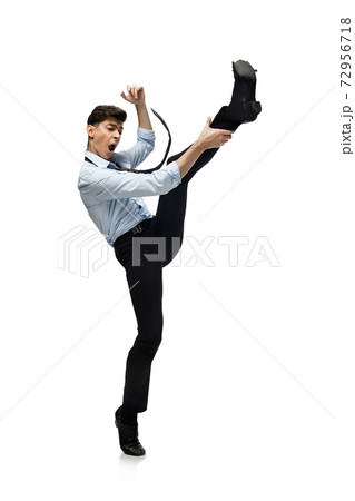Happy young man dancing in casual clothes or suit, remaking legendary moves of celebrity from culture history Happy young man dancing in casual clothes or suit, remaking legendary moves of celebrity from culture history 72956718