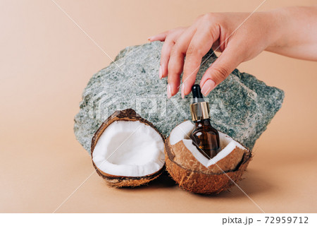 Coconut and a tube of cosmetics on a stone background 72959712